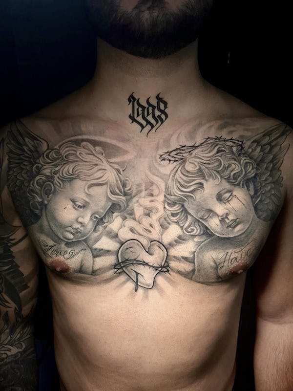 Cherubs chest tattoo by Alex, artist at Fattys Tattoos & Piercings