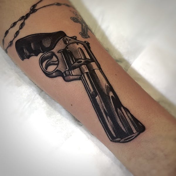 Handgun tattoo by Alex, artist at Fattys Tattoos & Piercings