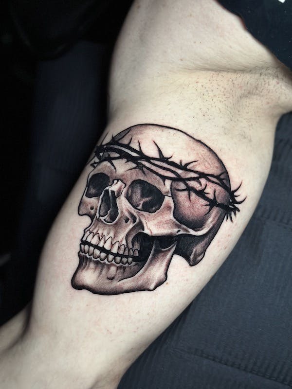 Skull with crown of thorns tattoo by Alex, artist at Fattys Tattoos & Piercings