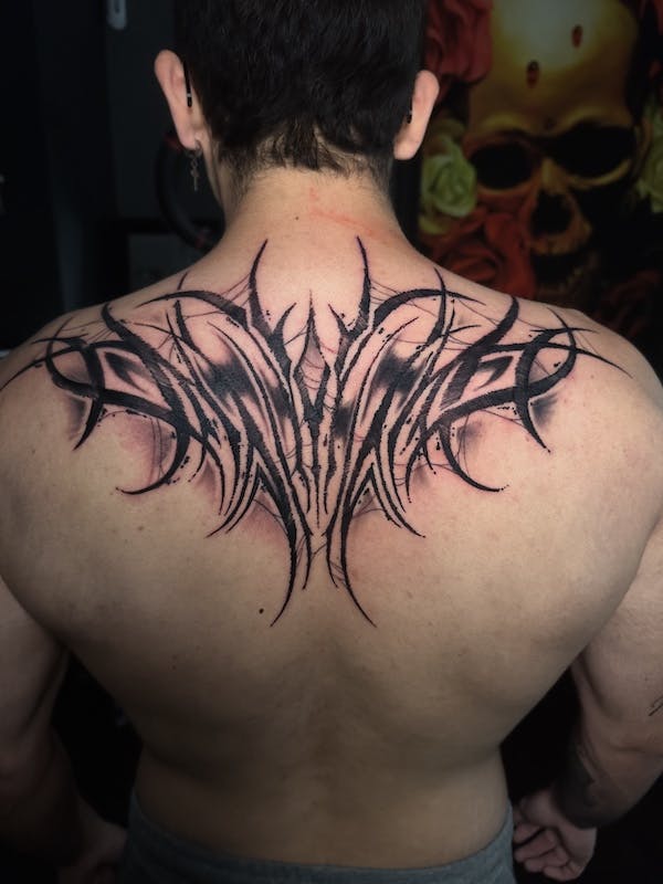 Tribal back piece tattoo by Alex, artist at Fattys Tattoos & Piercings